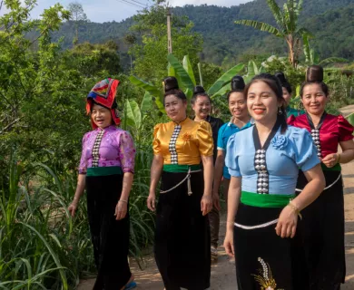 Vietnam_Women with unique buns wearing traditional clothing walking down the street